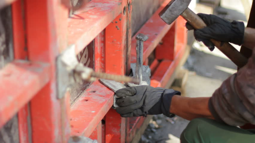  Worker hammers construction nail