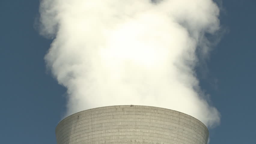 Steam rises from the cooling tower at a geothermal power station