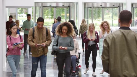 Students walking through the foyer of a modern university, shot on R3D