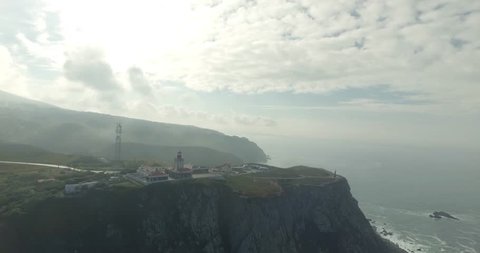 Cabo da Roca light house aerial video. Epic aerial footage of lighthouse standing on the edge of the cliff, Cape Roca, Portugal. Western point of Europe. Freedom, power concept.