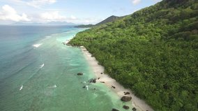 4k aerial video, bird eye view, drone fly over the Seychelles islands. Small tropical island. Islands in the ocean. Ocean. Sky. White sand. Beach. Waves. Island. Tropics. Silhouette island.