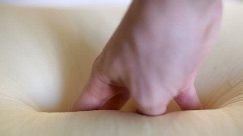 Two Hands of a man is Pressing on a Memory Foam Mattress bed Technology.