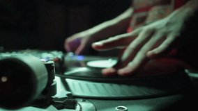  DJ scratching on the Decks at a disco / Nightclub