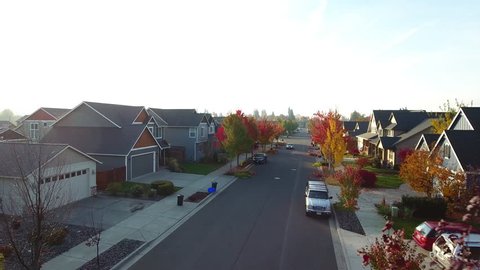 Early morning fly over a neighborhood in seasonal transition.