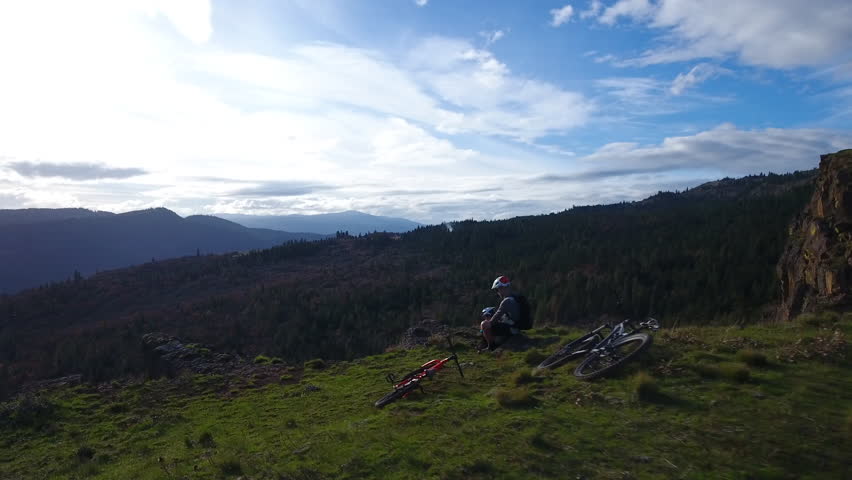 Aerial of father and son, taking in the beauty of the Columbia River Gorge at the top of Syncline.