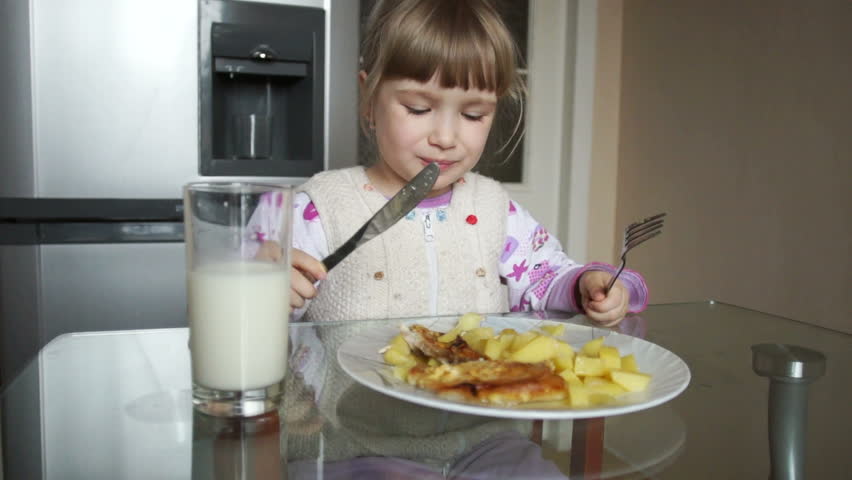 3 year old girl learns to use a knife and fork