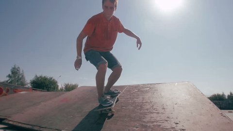 Skateboard fails. Skateboarder skateboarding and falling down doing tricks in a street. Slow motion.