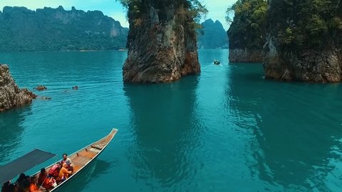 SURAT THANI, THAILAND May 6, 2016: Flying over the rocks and boat at the lake.