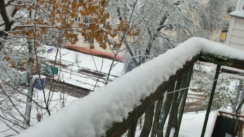 one man sculpt snow in hand