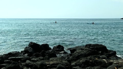 Two Canoes In Ocean Off Of Black Lava Rock Shore Kona Hawaii
