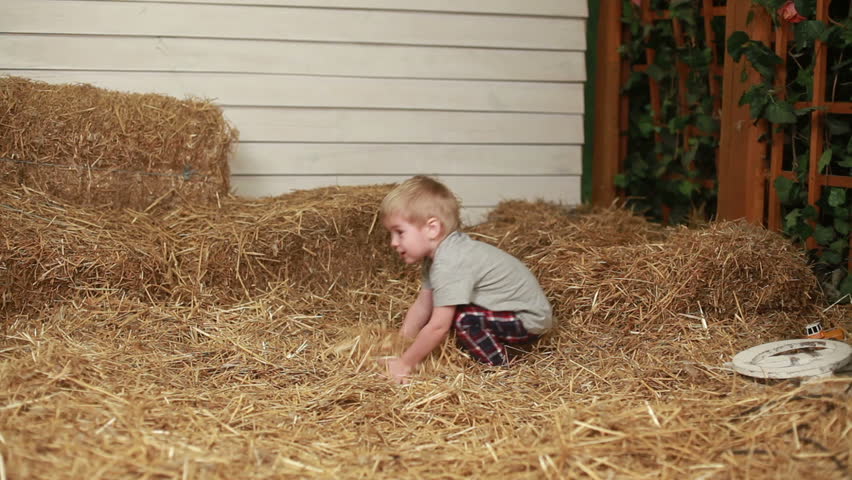 Happy boy throwing the straw indoors