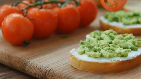 Cooking bruschetta with cream cheese, avocado and cherry tomatoes - Powered by Shutterstock - Get 15% off with code: PIKWIZARD15