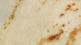 Slow tilt over tasty dessert surface ready to be filled and rolled 4K 2160p 30fps UltraHD footage - Close-up pancake fried texture after frying 3840X2160 UHD tilting video