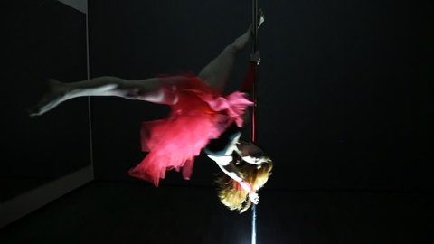 Girl in red skirt dancing pole dance