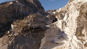Aerial shot, the worlds famous Carrara marble caves with the soft sunset light, filmed with drone