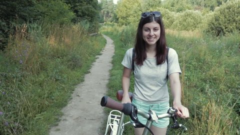 Girl With Bicycle Looking at Camera