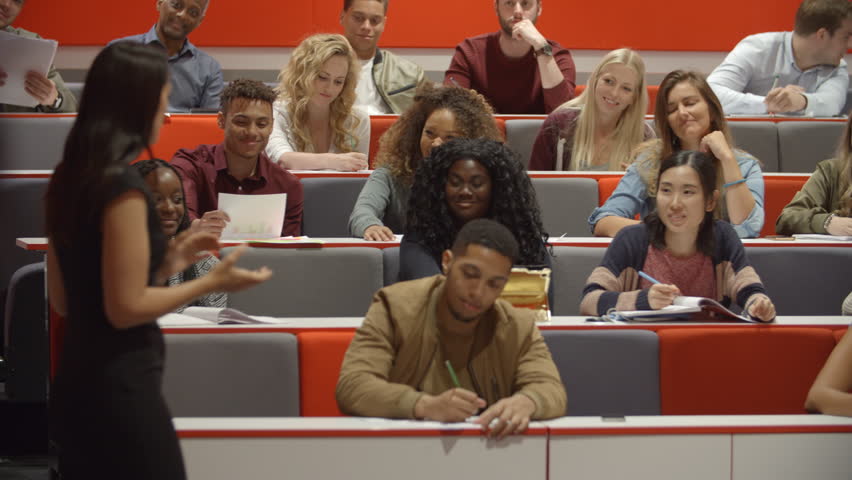 Female teacher and students in university lecture theatre