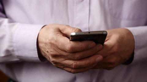 Old Man Text Messaging On Smartphone, Close Up