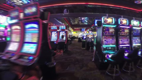 LAS VEGAS, NEVADA - April 21, 2016: (Steadicam shot) Walking through slot machines in casino in Las Vegas, Nevada, USA.