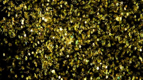 Gold Stars in Flight. Out of the darkness there is a multitude of small bright gold stars. Beautiful video for Christmas, New Year or any other holiday. Filmed at a speed of 240fps