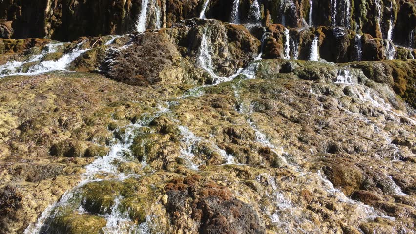 Huanglong Mountain with beautiful nature waterfalls with lime stone  in Sichuan , China on sunny day 