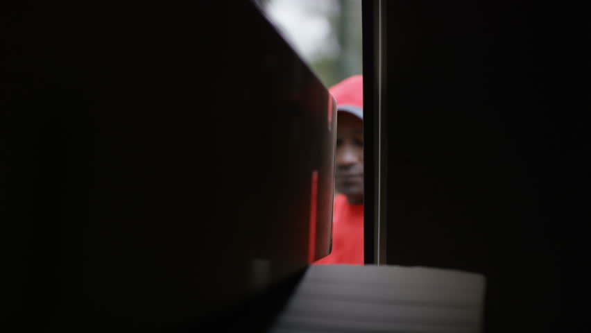 4K Delivery driver unloading boxes from the back of van, as seen from inside vehicle. Shot on RED Epic.