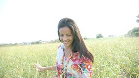 Attractive gypsy woman walking in country field