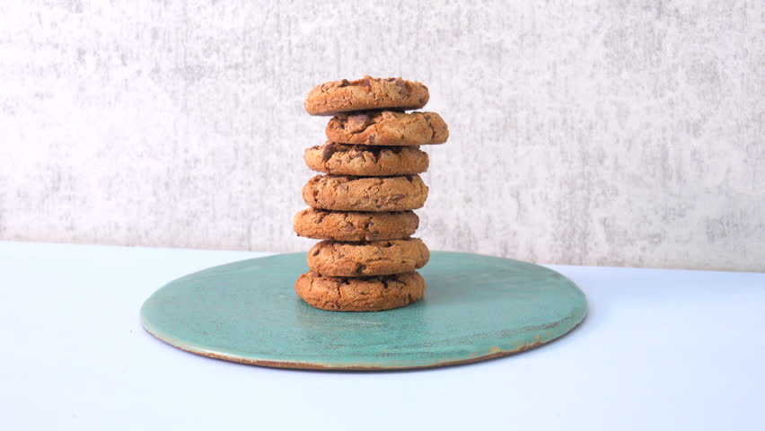 Stack of chocolate chip cookies on a plate. Homemade biscuits on a table.