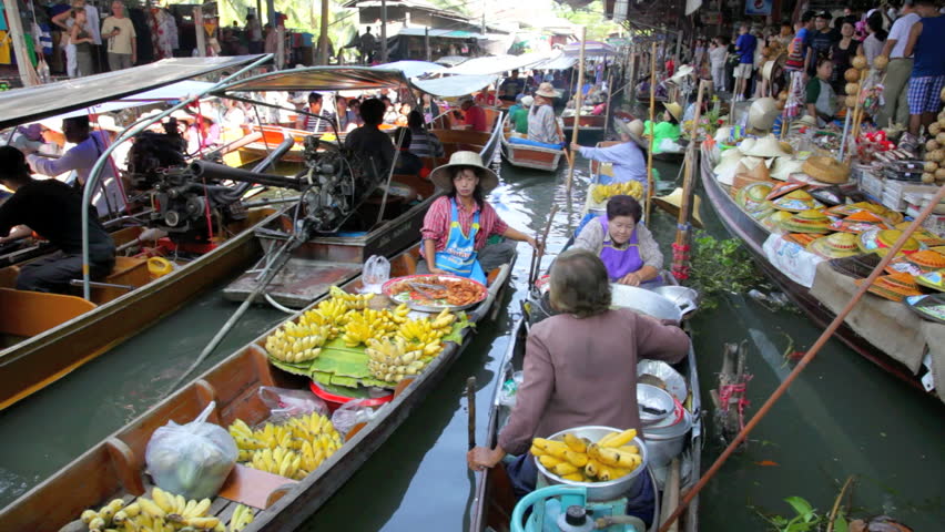 DAMNOEN SADUAK, THAILAND - FEBRUARY 25, 2012: Two women are selling food in