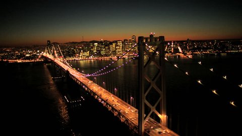 Aerial sunset view of the Oakland Bay Bridge at night with the illuminated light from cars, San Francisco city, North America, USA
