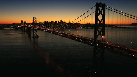Aerial sunset view of the Oakland Bay Bridge at night with the illuminated light from traffic, San Francisco, North America