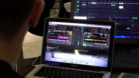 KHERSON, UKRAINE - NOVEMBER 12, 2016: Composer, Sound Engineer working at the Computer processes the Sound Program