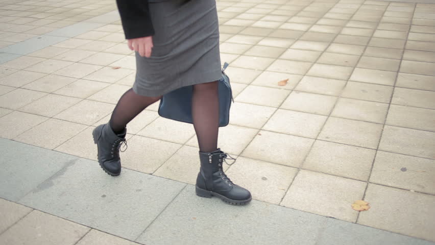 female feet walking on the street.