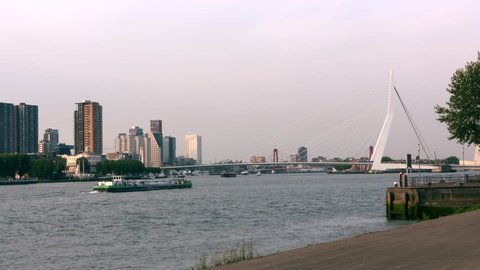 ROTTERDAM - AUGUST 2016: skyline Erasmus Bridge across Nieuwe Waterweg, linking the northern and southern regions of Rotterdam.View downstream, Veerhaven and Rotterdam central area at north side.