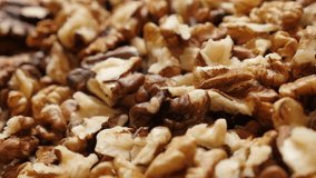 Slow tilt over walnut pile out its shell food ingredient background 4K 2160p 30fps UltraHD footage - Lot of Juglans regia fruit pieces 3840X2160 UHD tilting video