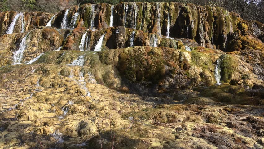 Huanglong Mountain with beautiful nature lime stone pond  ,waterfalls,lake  in Sichuan , China on sunny day 