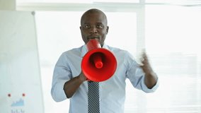 African-American businessman talking expressively in megaphone
