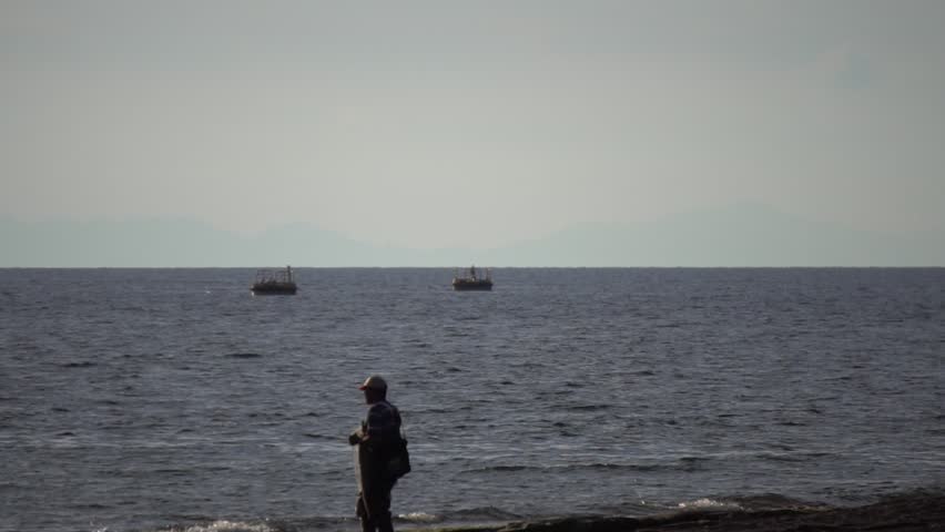 Fisherman Silhoutte wit sea