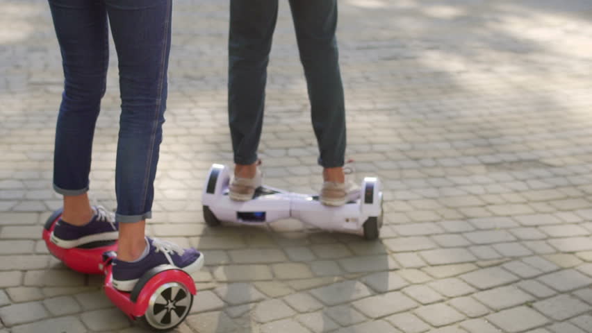 Young man and woman having fun with Hover board in the park. Content technologies. a new movement. Close Up of Dual Wheel Self Balancing Electric Skateboard Smart Royalty-Free Stock Footage #21332227
