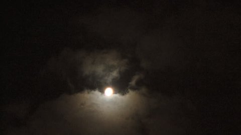 Clouds moving at full moon