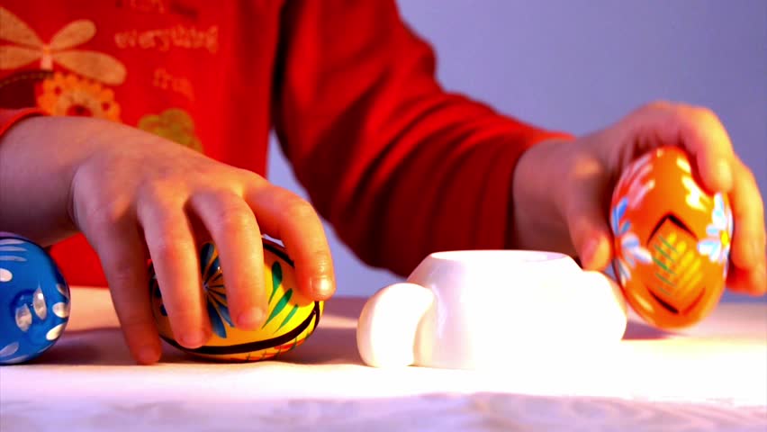 Kid is playing  Easter egg (close-up)