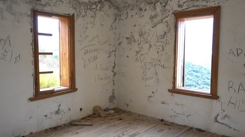 4K Inside of forsaken house, dirty room with empty window frames

