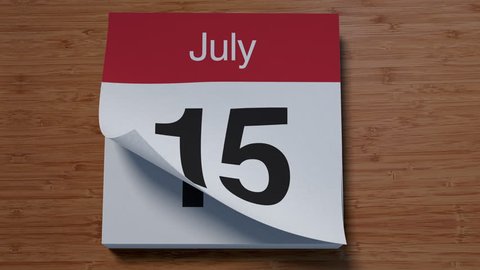 Calendar for July on wooden table flipping through days of month