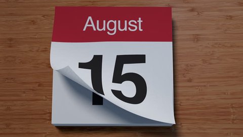 Calendar for August on wooden table flipping through days of month