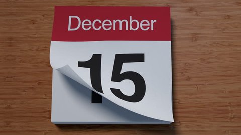 Calendar for December on wooden table flipping through days of month