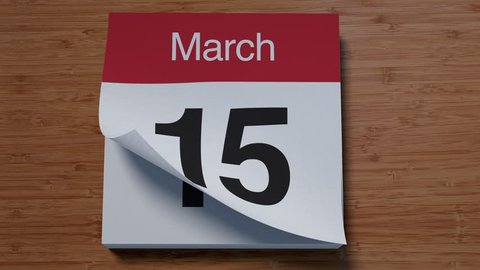 Calendar for March on wooden table flipping through days of month
