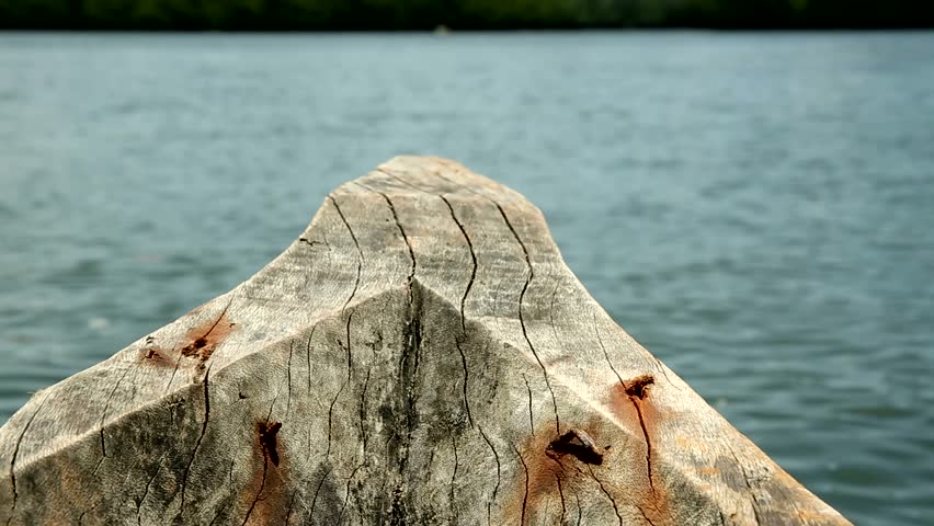 Close-up of the front bow of a traditional boat speeding across the sea, capturing motion, waves, and the essence of tropical marine adventure.