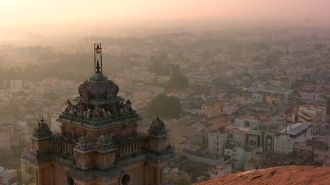 A temple complex and a beautiful view over a city in India during sunrise