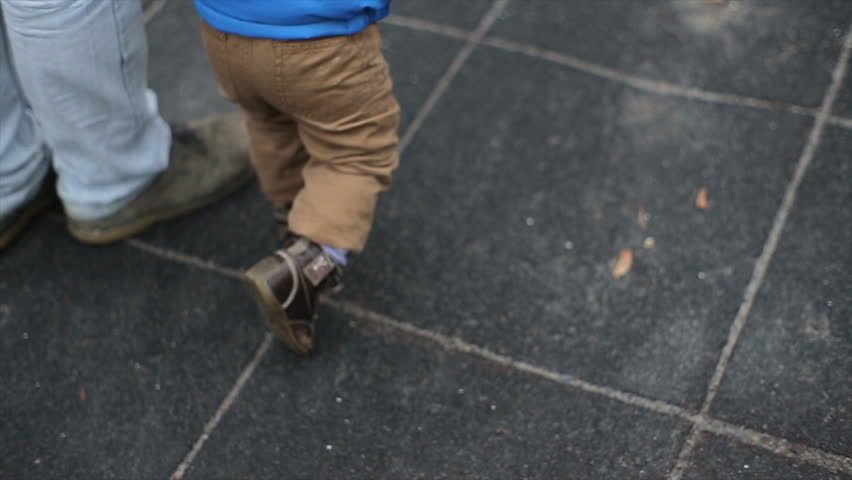 Little boy have fun with his parents at a playground