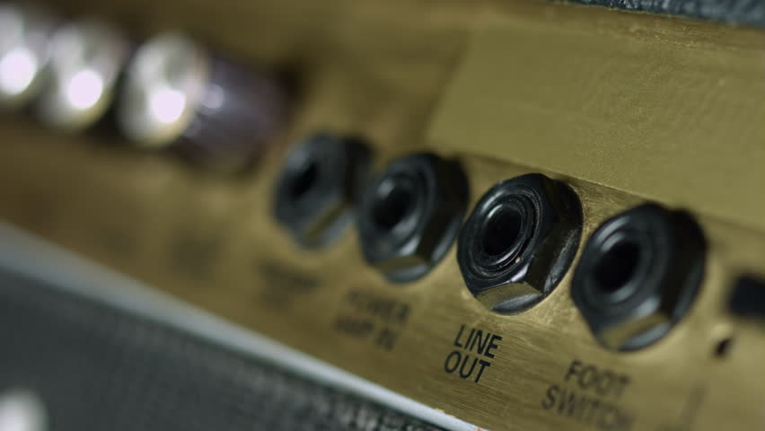 Close up of plugging in auido cable in line out jack